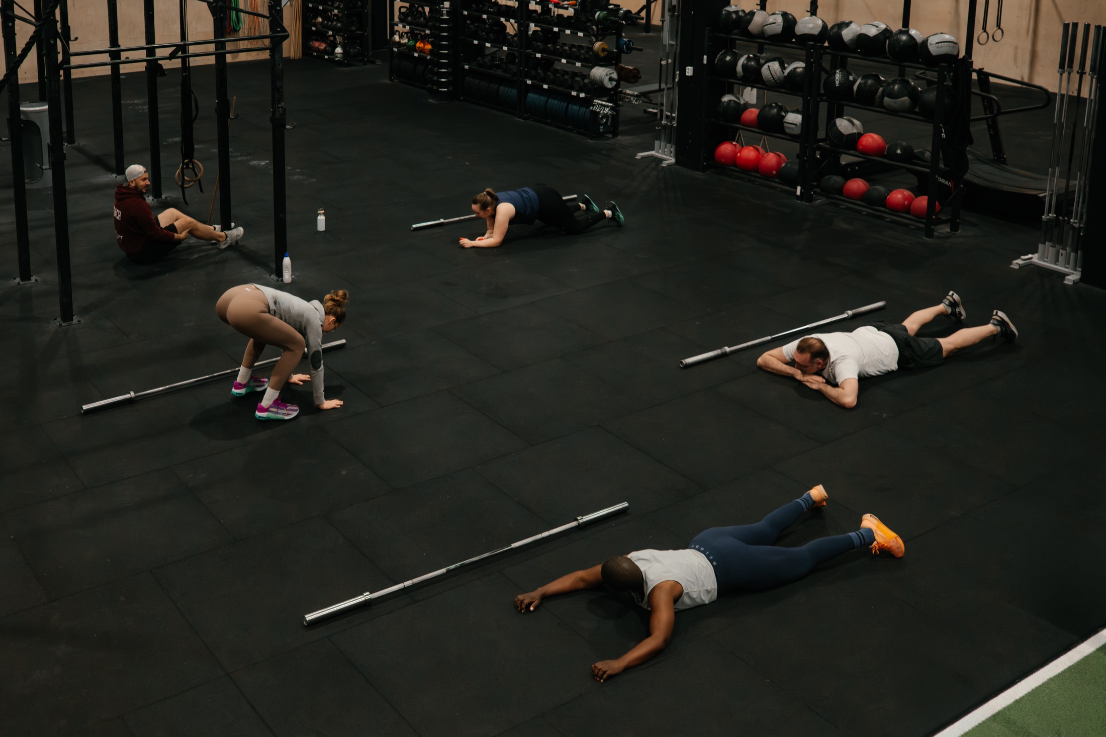 Crossfit athletes resting after a workout inside the gym