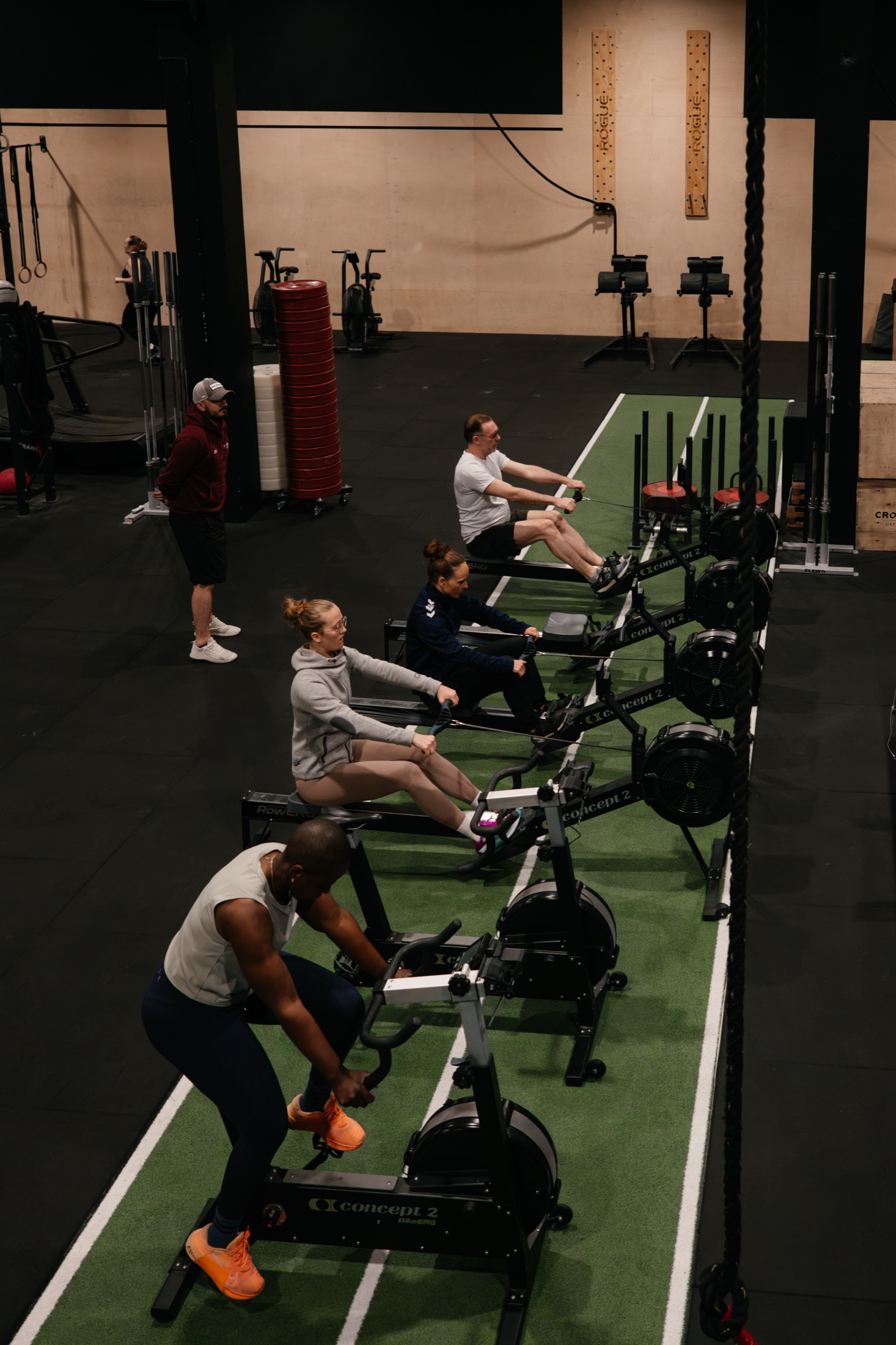 Crossfit athletes training on rowing machines